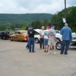 Folks check out all the classic cars (Handheld) Folks check out all the classic cars