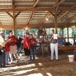 Bob Connell goes of the rules of the Goat Milking Contest (Bob is a past Goat Milking Champion)