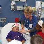 Emergency Department Clinical Supervisor Kathy Hickmon, RN, shows the McRae Elementary School students how the Emergency Room nurses connect patients to a computer to monitor their vital signs