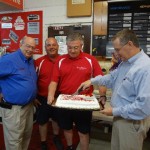 Boris Dover cuts the cake as Johnny, Ronny and Bobby look on
